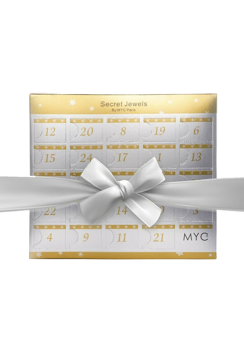 Calendario dell'Avvento in una combinazione di colori oro e bianco, decorato con un grande fiocco bianco, motivi a fiocco di neve e cassetti regalo numerati.