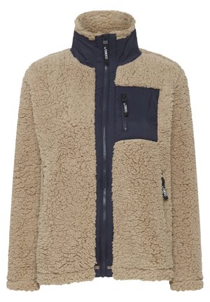 Fleecejakke med en beige tekstureret overflade og navy nylon frontpaneler. Har en høj krave og en lynlåslomme på brystet.