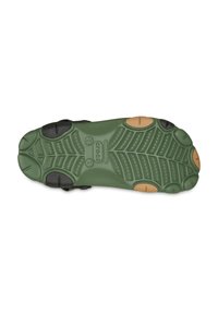 Groene rubberen zool met een patroon voor grip, afgewerkt met zwarte en tan secties. Textuur voor traction en duurzaamheid.