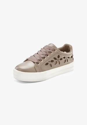 Beige leather sneaker with cut-out floral design, flat white sole, and wide satin laces. Textured finish with gold-tone hardware accents.