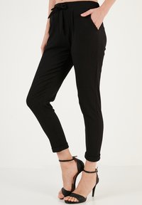 LELA SLIM FIT - Trousers - black