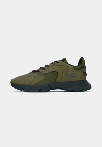 Green sneaker featuring a textured upper, dark outsole, and black laces. Subtle accents include a logo on the side and padded collar.
