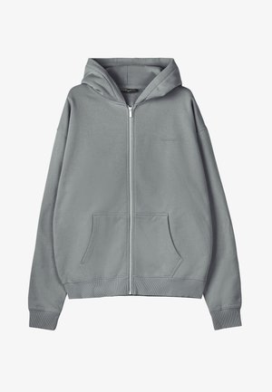 Harmaa vetoketjullinen huppari kengurutaskulla, resorit hihoissa ja helmassa, pehmeää kangasta. Varustettu hupulla ja hillityllä rintalogoilla.