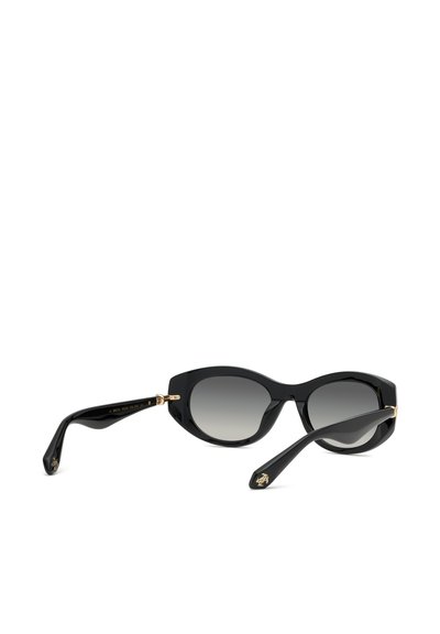 Lunettes de soleil noires forme œil de chat avec verres gris dégradés et détails dorés sur les branches, reposant sur une surface blanche.