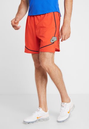 Men's orange athletic shorts with a black line design and logo; made of lightweight material, featuring an elastic waistband and side pockets.