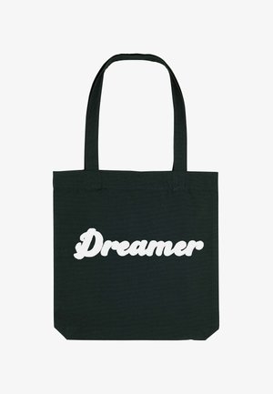 Mustvalge puuvillane kott, millel on suur valge, kaligraafiaga tekst "Unistaja". Kotil on kaks tugevat külge.