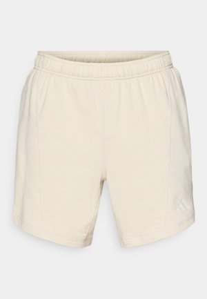 Lichtbeige shorts van zacht stof, met een elastische tailleband, zijnaad en een klein, subtiel logo op het onderste deel van het linkerpootje.