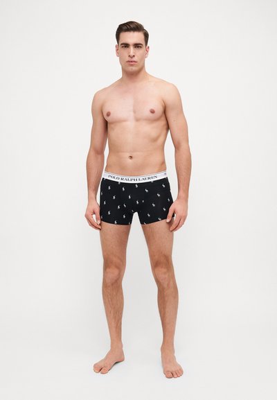 Mustat boxerit valkoisella Polo Ralph Lauren -logolla vyötäröllä; sisältää pieniä valkoisia polo-pelaajaprinttejä ympäriinsä. Pehmeä, joustava materiaali.