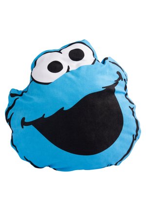 Cuscino blu con il volto di un personaggio dei cartoni animati, caratterizzato da grandi occhi neri e un ampio sorriso nero. Tessuto morbido con una forma arrotondata.