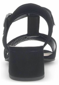 Sandal nero con tacco a blocco, con apertura sul retro e cinturino regolabile alla caviglia. Il materiale sembra liscio con una finitura opaca.