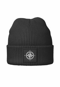 Black knitted beanie with vertical ribbing, featuring a square patch with a compass design in white. Smooth texture and foldable brim.