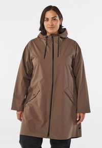 Bruine waterdichte jas met een capuchon, verstelbare trekkoorden, een voorrits en zijzakken. Gladde textuur met een relaxte pasvorm.