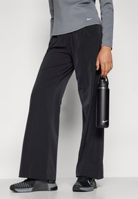 Nike Performance BLISS TROUSER - Kelnės - black