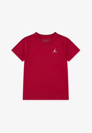 Red cotton T-shirt with a crew neck and short sleeves. Features a small white Jumpman logo on the left chest. Smooth texture.