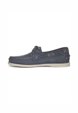 Navy blue leather boat shoe with white sole, moc toe stitching, and lace threading through gold eyelets on the sides.