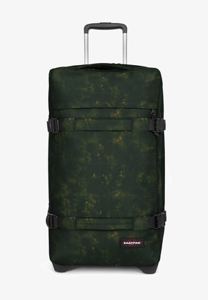 Grüne Reisetasche mit einem strukturierten Muster, ausgestattet mit schwarzem Zubehör, seitlichen Kompressionsriemen und einem teleskopischen Griff für eine einfache Handhabung.