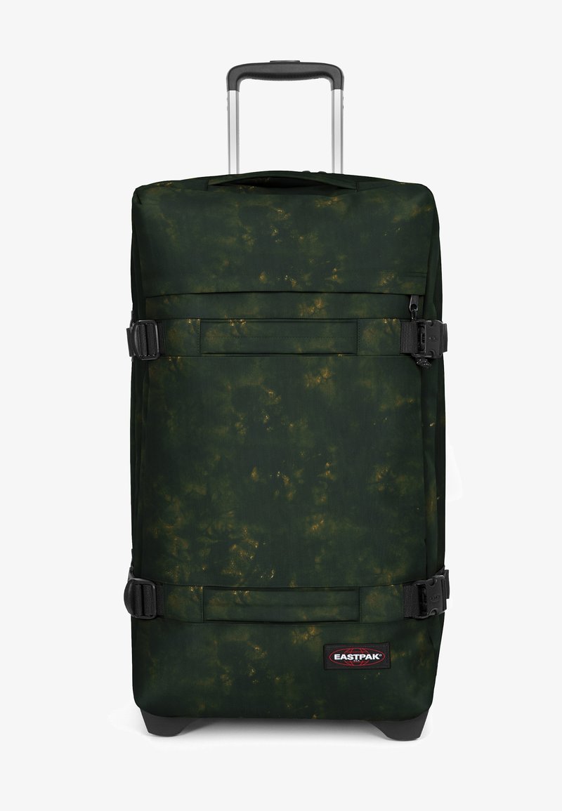 Grüne Reisetasche mit einem strukturierten Muster, ausgestattet mit schwarzem Zubehör, seitlichen Kompressionsriemen und einem teleskopischen Griff für eine einfache Handhabung.