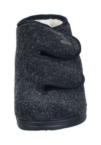 Gray wool slipper with a rounded design, featuring a soft texture, velcro straps, and a rubber sole for grip. Logo displayed on the side.