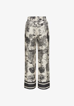 Wide-leg cream pants with black detailed wildlife and tree print, elastic waistband, and black double-stripe trim at hems.