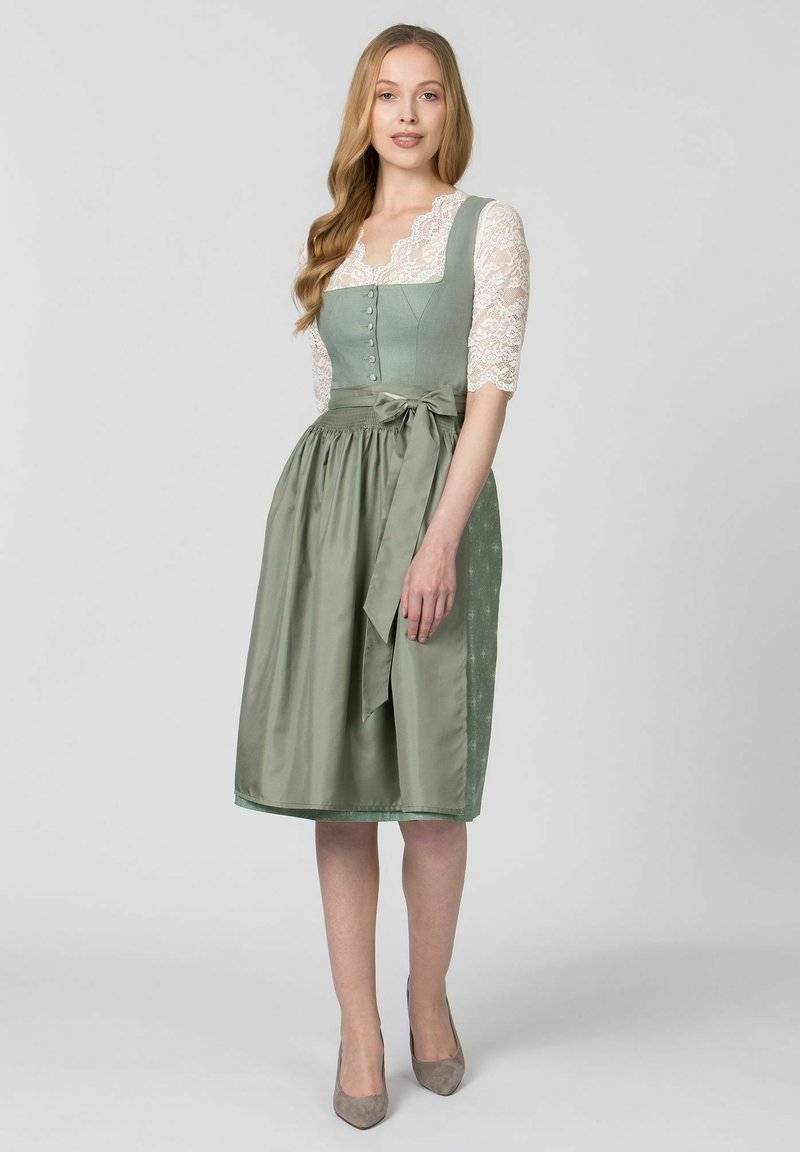 Light green dirndl dress with lace sleeves, square neckline, buttoned bodice, and a bow at the waist. Smooth satin texture with a gathered skirt.