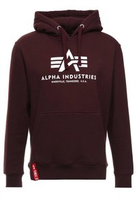 Felpa maroon di Alpha Industries con logo bianco e testo "Alpha Industries Knoxville, Tennessee, U.S.A." e un'etichetta rossa sull'orlo.