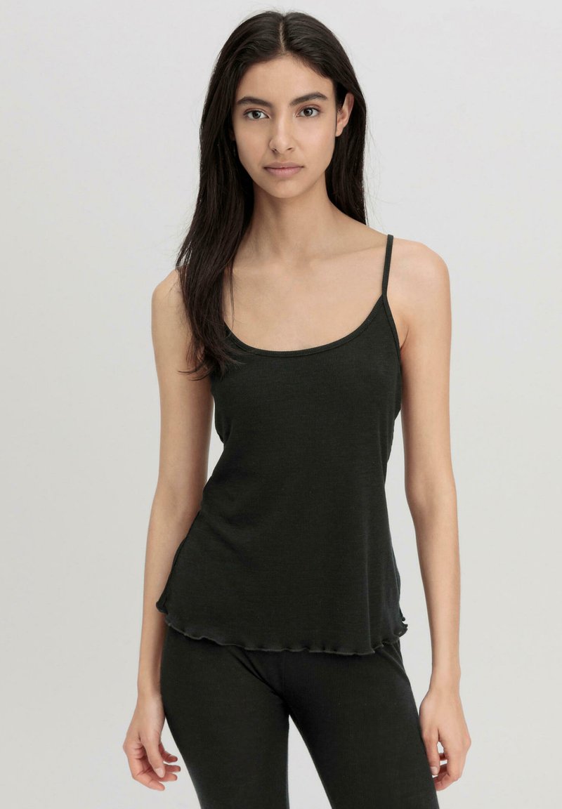 Black tank top with thin straps, soft fabric, relaxed fit, and scalloped hemline. Paired with matching bottoms for a cohesive look.