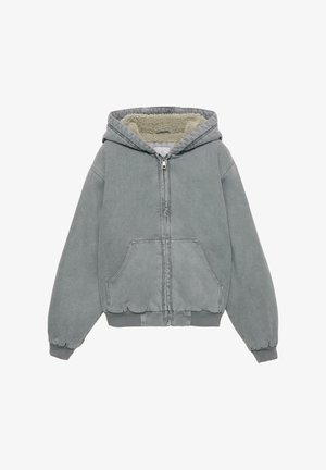 Harmaa vetoketjullinen huppari, jossa pehmeä fleecevuori, joustavat hihansuut ja kaksi etutaskua. Varustettu nyörillä säädettävällä hupulla ja pehmeällä, teksturoidulla kankaalla.