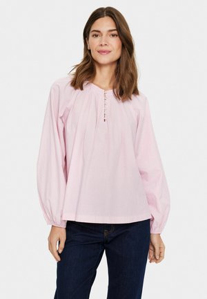 Pink long-sleeve blouse with a round neckline, front pleats, and button details. Material appears lightweight and smooth, with elastic cuffs.