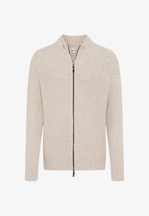 Cardigan en tricot beige à zip, avec col montant, texture côtelée, manches longues et fermeture à glissière sombre.