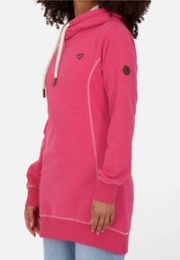 Felpa rosa con colletto a cowl, dotata di lacci bianchi, piccolo emblema a forma di cuore e cuciture a contrasto. Realizzata in morbido tessuto testurizzato.