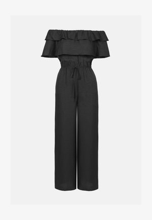 Combinaison noire à épaules dénudées avec un col à volants, taille élastique et jambes larges et fluides. Fabriquée en tissu léger texturé.