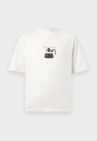 White cotton t-shirt featuring a graphic of a coffee pot with the text "Café du Choix" in cursive above it. Short sleeves, relaxed fit.