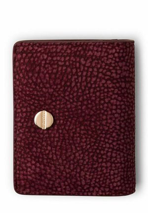 Compact textured burgundy wallet with rounded corners and a small round gold clasp with vertical detail in the center.