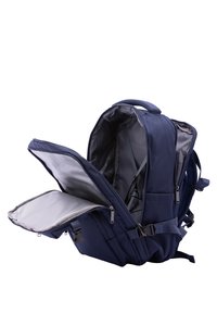 Navy blue backpack made of durable fabric, featuring multiple compartments, adjustable straps, and a gray-lined interior. Zipper and buckle closures.