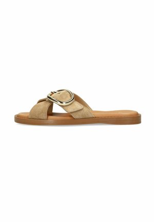Beige suede flat slide sandal with wide cross straps and large silver buckle, brown sole, open toe and heel.