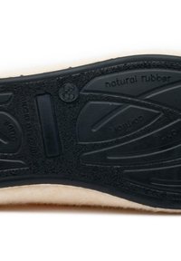 Black rubber sole with textured surface, featuring a beige cushioned upper edge and embossed text indicating "natural rubber" and size 38.