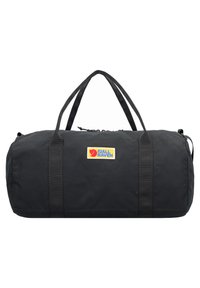 Bolsa de deporte negra hecha de un tejido duradero, que cuenta con dos asas resistentes, un cierre de cremallera y un parche de logo amarillo. Diseño liso y estructurado.