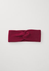 Burgundy knit headband featuring a twisted design at the front and a small embossed logo on the side. Soft texture and wide shape.