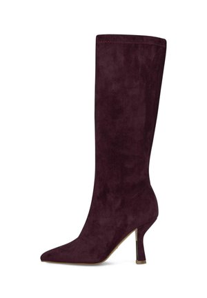 Bota alta de ante morado oscuro para mujer con puntera puntiaguda y tacón delgado de altura media sobre un fondo blanco.