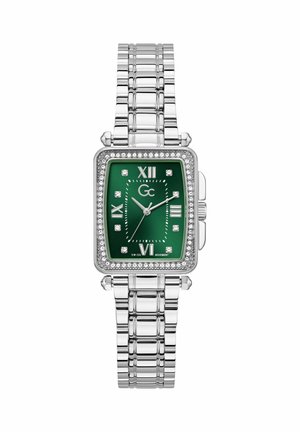 Hõbedast metallist käekell rohelise ristkülikukujulise sihverplaadiga, rooma numbrite, kristallist tundmärgiste ja kristallidega kaunistatud raamiga.