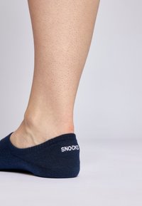 Calza alla caviglia blu navy realizzata in tessuto testurizzato con una finitura liscia, caratterizzata dal logo bianco "SNOCKS" sul tallone. Adatta per l'abbigliamento informale.