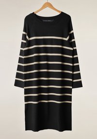 Abito a strisce nere e crema con maniche lunghe, scollatura tonda e spacchi laterali. Realizzato in tessuto a maglia con una texture morbida.
