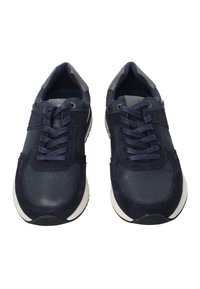 Pár tmavě modrých tenisek s tkaničkami, mix jemné kůže a kůže, a bílými podrážkami, zobrazený zepředu na bílém pozadí.