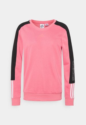 Lyserød sweatshirt med lange ærmer med sorte skulderpaneler, hvide striber på underarmene og Adidas-logo på venstre arm og bryst.