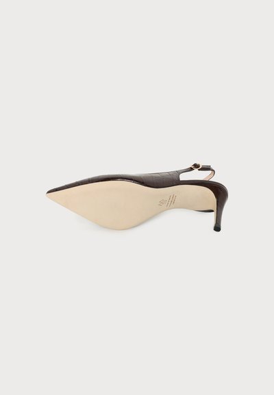 Escarpin slingback à bout pointu en cuir texturé marron foncé avec une semelle beige vu de dessous sur fond uni.