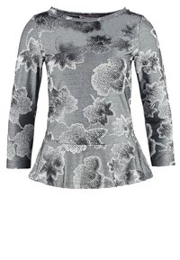 Gray long-sleeve peplum top with large black and white floral patterns and a round neckline.