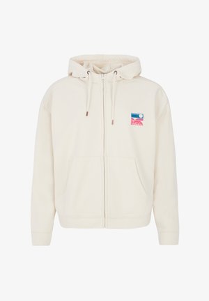 Crème zip-up hoodie met een trekkoordcapuchon en voorzakken. Bevat een kleurrijke logo patch met elementen in blauw, roze en wit.