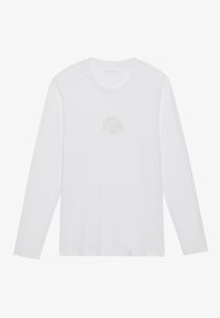 White long-sleeve crewneck shirt with a subtle circular emblem and text on the chest, laid flat on a white background.