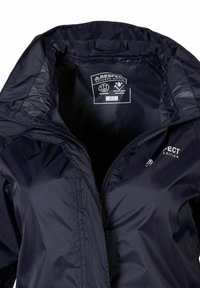 Veste imperméable navy avec une fermeture éclair complète, un col ajustable et un intérieur doux et texturé. Étiquette de marque visible à l'intérieur de l'encolure.