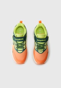 Orange and green athletic shoes with a mesh upper, rubber sole, and Velcro strap. Features a bright lime insock and Kangaroos branding.